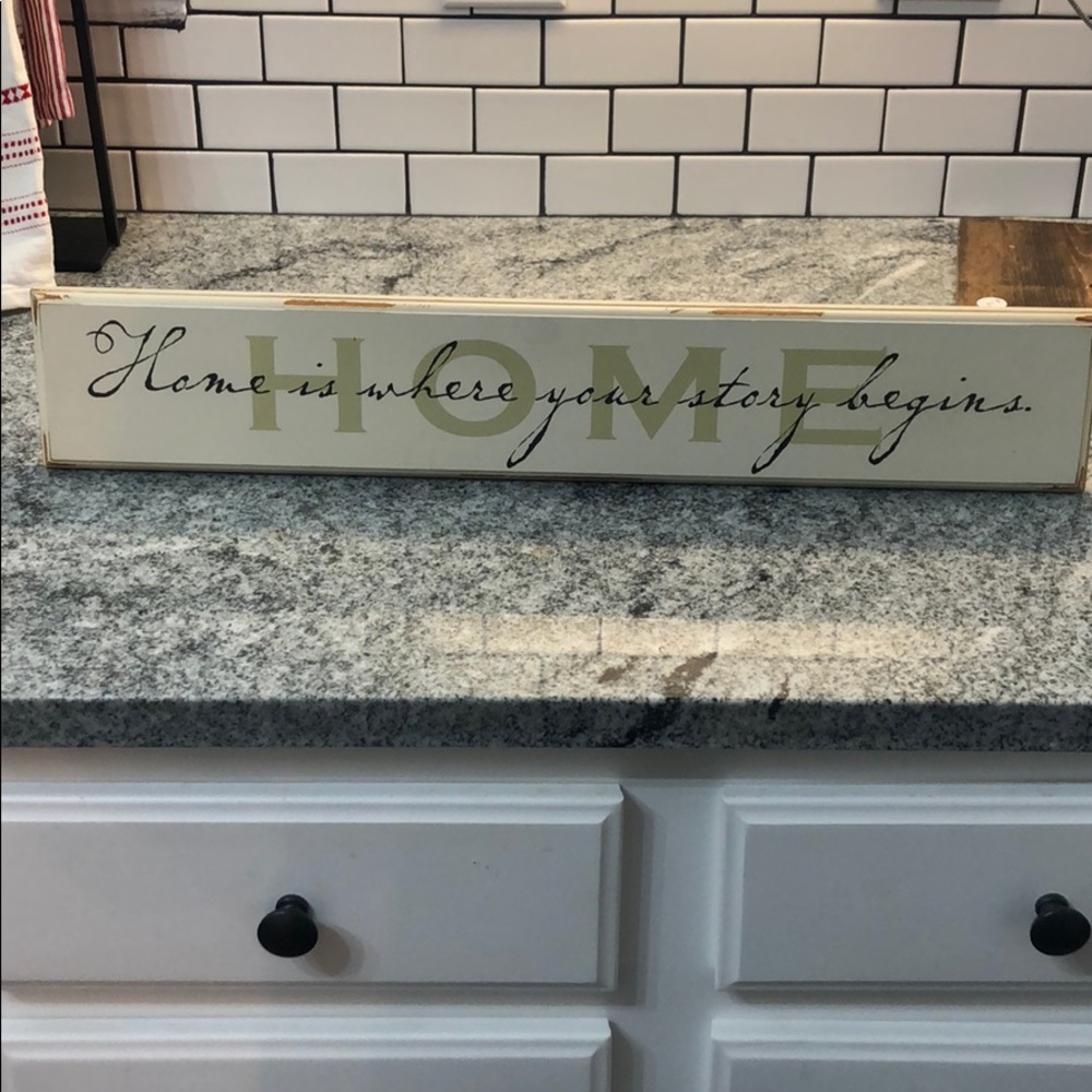 “Home is where your story begins” sign